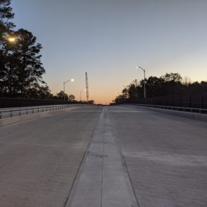 Four-lane roadway and bridge with traffic separated by concrete median