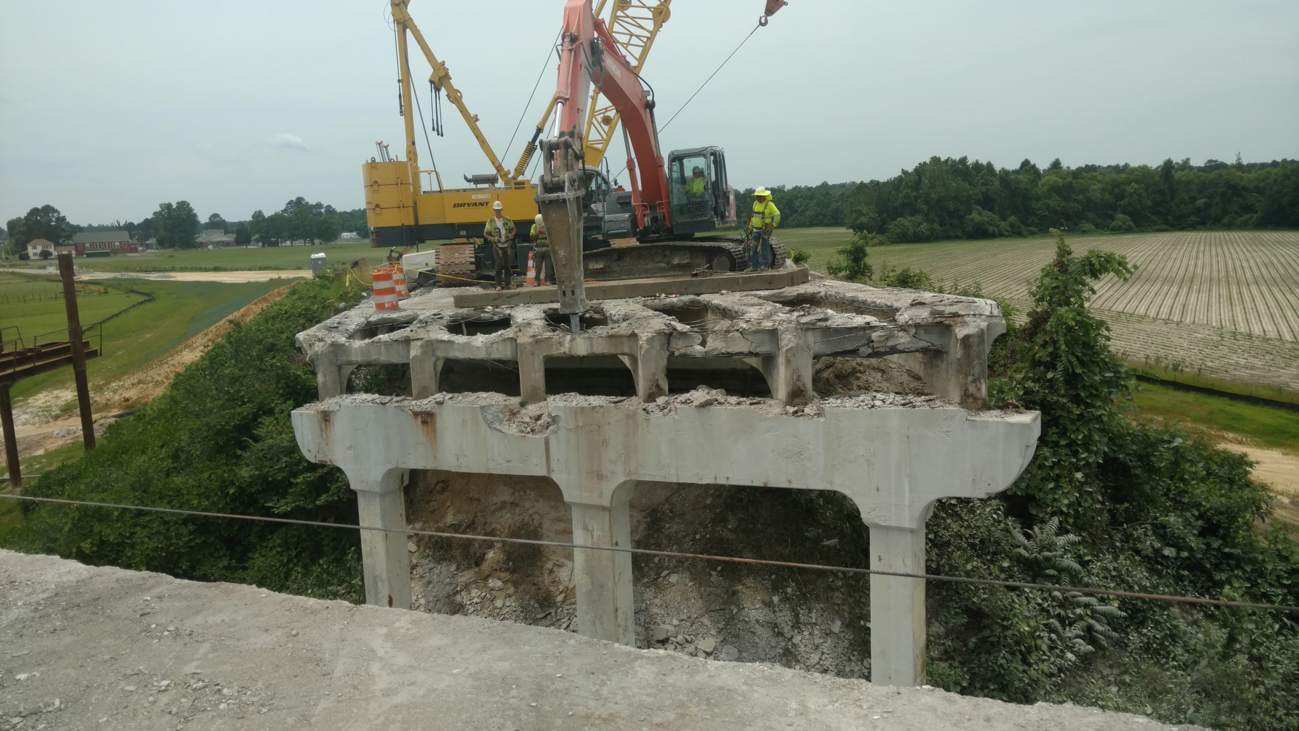 Demolition of existing bridge deck with Hitachi excavator and hoe ram attachment