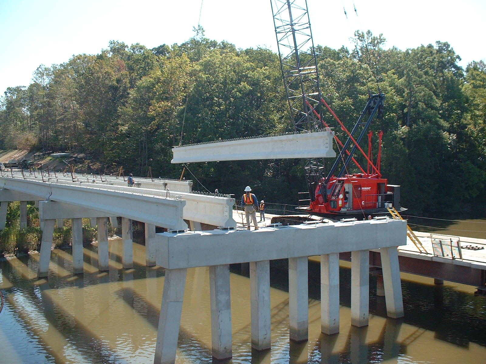 Erecting beams from temporary work trestle