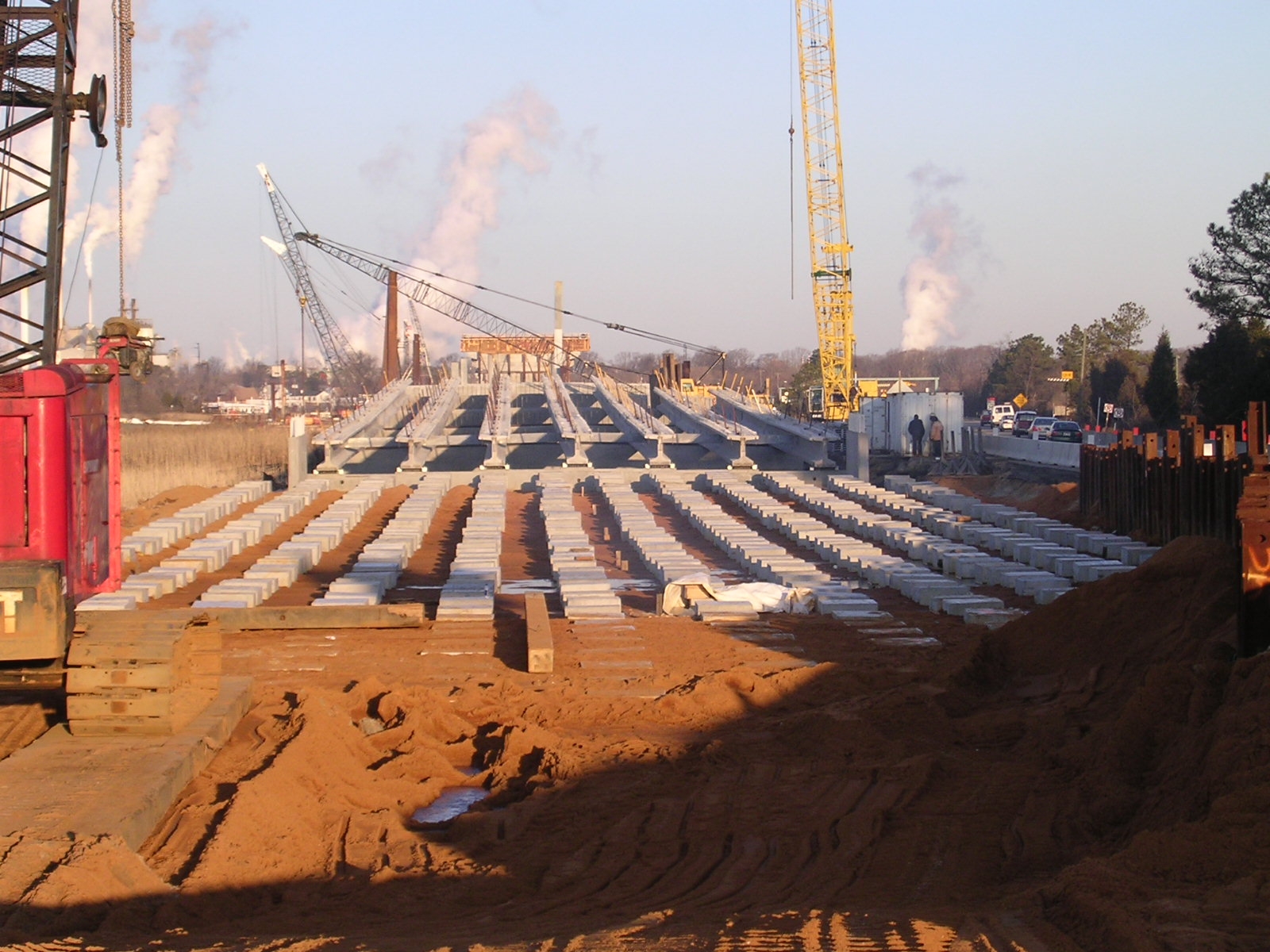 Bridge approach supported by concrete piles and precast concrete pile caps.