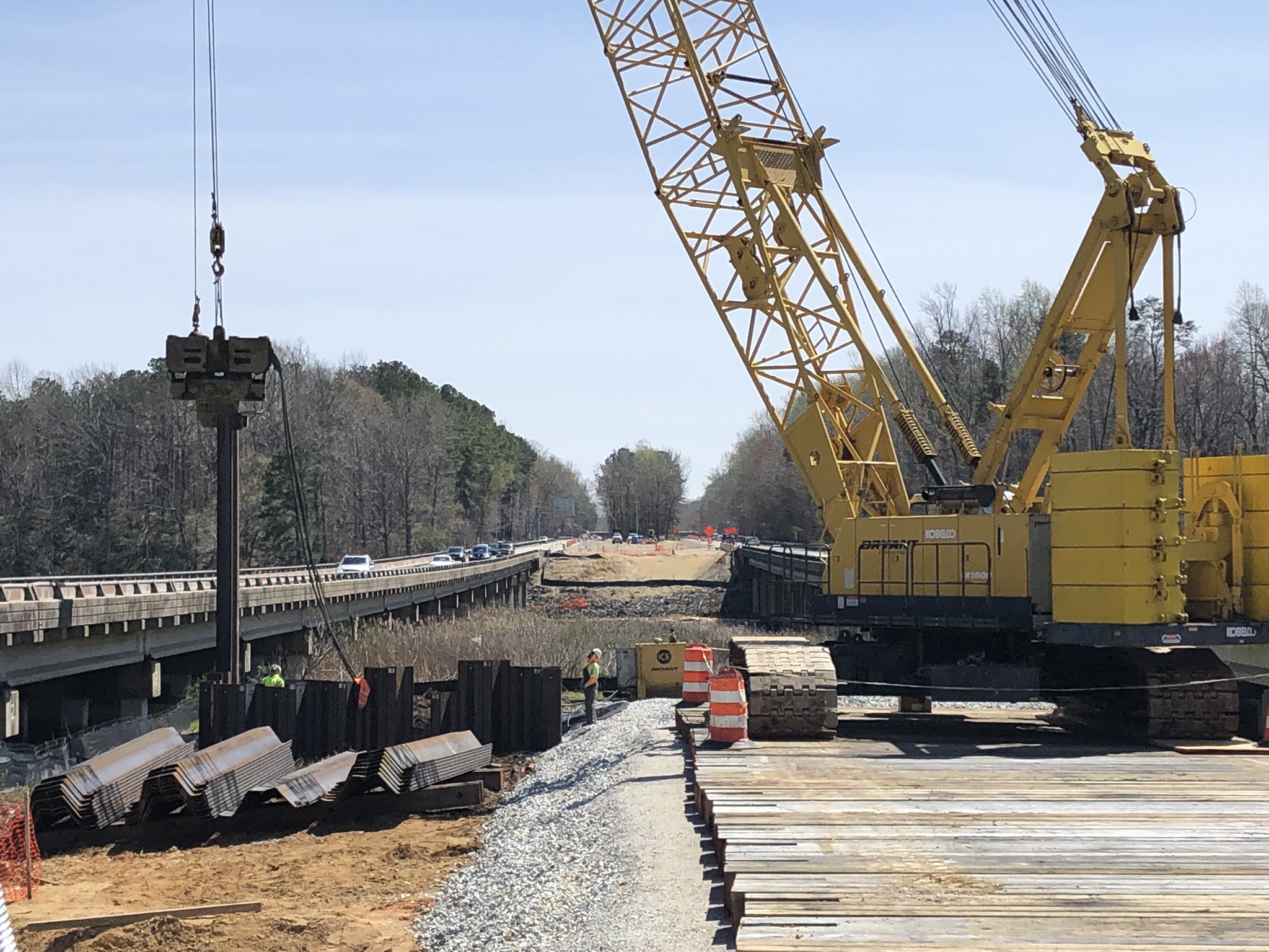 Temporary sheet pile wall and bridge access road construction
