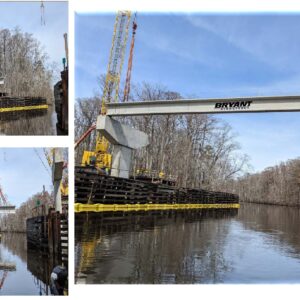 Setting beams over the Blackwater River with a 275-ton and 160-ton crawler crane.